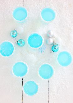 blue and white desserts are arranged in the shape of snowflakes with ornaments on them