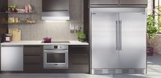 a modern kitchen with stainless steel appliances and cabinets