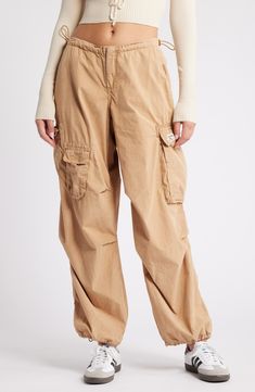 These Y2K-inspired cargo pants feature a baggy low-rise silhouette, plenty of pockets and a toggle-adjustable waist. 29 1/2" inseam; 12" leg opening; 10" front rise; 14 1/2" back rise (size medium) Exclusive retailer Zip fly with hook-and-bar closure Drawcord-toggle waist Front slant pockets; back patch pocket; cargo flap-patch and flap-bellows pockets 100% cotton Machine wash, line dry Made in Turkey Mnml Bungee Cord Pants, Tan Cargo Pants Women, Yellow Hiking Pants, Cheap Urban Outfitters Summer Pants, Khalana Barfield For Target, Low Rise Tan Cargo Pants, Zara Cargo Joggers, Bdg Cargo Pants, Cuffed Cargo Pants