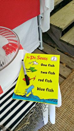 a dr seuss one fish two fish red fish blue fish sign on a table