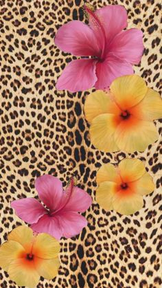 two pink flowers sitting on top of a cheetah print background with leopard spots