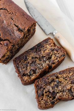 three slices of chocolate chip banana bread next to a knife