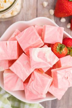 a bowl filled with marshmallows and strawberries