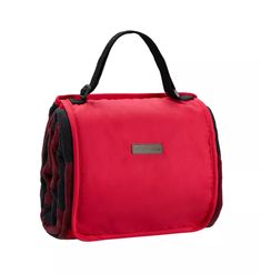 a red bag with black straps on it