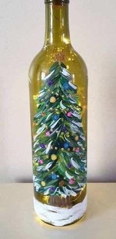 a bottle with a christmas tree painted on it