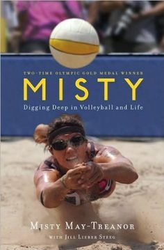 a woman dives for a volleyball ball on the beach