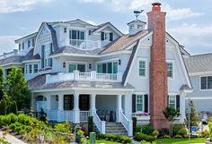 a large white house with lots of windows and balconies