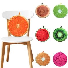 an orange slice sitting on top of a white chair next to other pieces of fruit