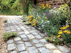 a garden with flowers and rocks in the middle