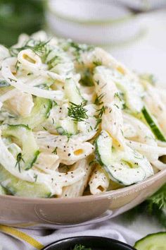 pasta salad with cucumbers and herbs in a bowl