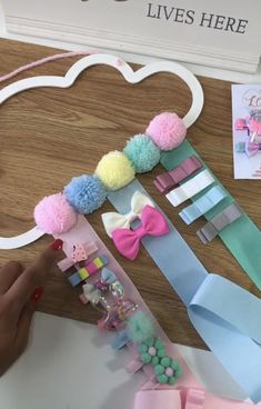 a person is making some paper crafts with pom - poms and other items