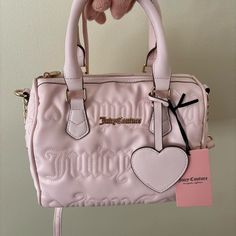 Juicy Couture Pink Handbag With Straps. This Bag Is Super Cute And Has Embroidered Detail All Over Of Spell Out Of “Juicy” And Hearts. Best Sellers Fame Satchel Handbag/ Purse. This Beautiful Color Is Light Pink/ Powder Blush. This Bag Will Look Phenomenal With A Light Pink/ White/ Off White/ Black/ Jet Black Juicy Couture Track Suit; Hoodie And Sweatpants. Brand New Authentic Juicy Couture Nwt Juicy Couture Track Suit, Black Juicy Couture, Pink Handbag, Pink Powder, Juicy Couture Purse, Black Jet, Hoodie And Sweatpants, Pink Handbags, Juicy Couture Bags