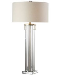 a lamp with a white shade on top of it and a beige lampshade