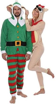 man and woman dressed up in christmas pajamas posing for the camera with an elf costume on