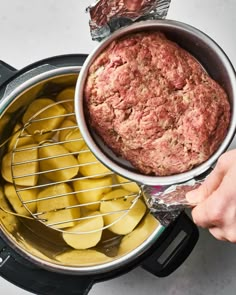 the meatloaf is being cooked in an air fryer with potatoes and bananas