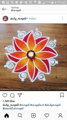 an image of a flower painted on the floor with white and orange colors, in front of a wooden table