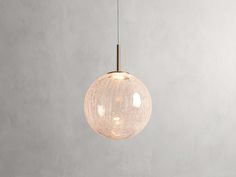 a light that is hanging from the ceiling in a room with concrete walls and flooring