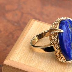 Estate/ vintage 14KT yellow gold large, lapis lazuli Roman/ Geek filigree ring. Etched filigree design band and undercarriage. Size 6.75 Can be resized (sized up or down) Inquire for pricing. Ring weight: 13.40 grams 23mm x 18mm genuine lapis Large, oval, vivid blue, lapis stone prong-set in yellow gold. Filigree design Stamped 14K and hallmarked Excellent estate condition Luxury Oval Lapis Lazuli Rings, Luxury Lapis Lazuli Oval Rings, Elegant Lapis Lazuli Rings For Formal Occasions, Elegant Formal Lapis Lazuli Rings, Gold Oval Lapis Lazuli Jewelry, Oval Gold Lapis Lazuli Jewelry, Oval Lapis Lazuli Rings For Formal Occasions, Formal Lapis Lazuli Oval Rings, Vintage Oval Lapis Lazuli Jewelry