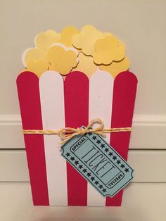 a red and white striped box filled with popcorn