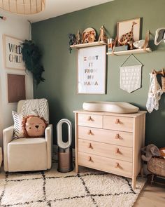 a baby's room with green walls and white carpet