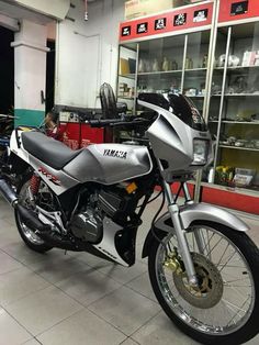 a silver motorcycle parked inside of a building