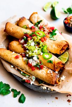 some food is sitting on top of a paper plate and garnished with cilantro