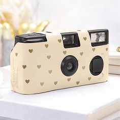 a camera with hearts on it sitting on a table