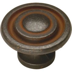 an old metal knob with a brown center