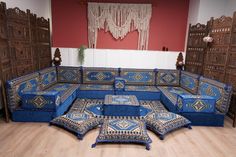 a blue couch sitting on top of a wooden floor