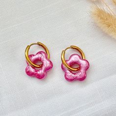 Pink Resin Flower Charm Huggie Hoop Earrings - Hypoallergenic Stainless Steel, Hypoallergenic Earrings, Handmade Jewelry, Gift For Her Add a touch of charm to your style with these delightful colored resin flower-shaped charm huggie hoop earrings. Each earring features a meticulously crafted flower charm made from high-quality uv resin, suspended from a sleek 19mm stainless steel huggie hoop. The stainless steel hoop offers durability and a hypoallergenic design, making it ideal for those with s Cheap Pink Huggie Earrings Gift, Pink Round Earrings With Flower Charm, Trendy Handmade Flower Hoop Earrings, Trendy Hypoallergenic Gold Flower Earrings, Trendy Flower Shaped Hoop Earrings Gift, Trendy Flower Hoop Earrings, Hoop Flower Charm Earrings As Gift, Small Hoop Earrings With Flower Charm As Gift, Small Hoop Pink Flower Earrings