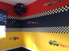 a child's room with cars painted on the walls and checkered wallpaper