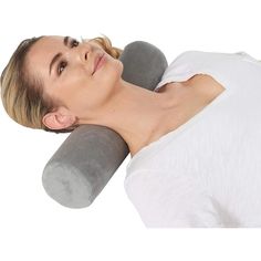 a woman is laying down with a neck pillow