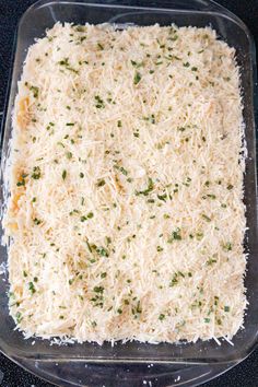 a casserole dish filled with cheese and parmesan sprinkles