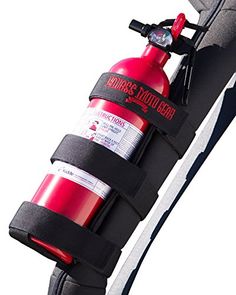 a red fire extinguisher attached to the side of a black bag with straps