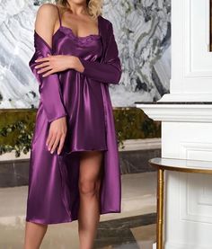 This elegant purple satin chemise and robe set is designed to captivate with its sophisticated details. The set features: Fabric: Soft and lightweight satin Color: Purple Cut: Mini length Lace Accents: Delicate lace details on the top Set Includes: Chemise and robe The chemise and robe are thoughtfully coordinated to offer a graceful look, making it a perfect choice for special occasions or a comfortable night in. Why You Should Buy It: Sophisticated Elegance: The rich purple satin and lace acce Long Sleeve Satin Nightgown For Party, Purple Satin Dress For Night Out, Purple Satin Sleepwear, Robe Pajamas, Satin Chemise, Adult Pajamas, Women's Nightgowns, Purple Satin, Satin Color