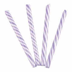 four purple and white striped paper straws