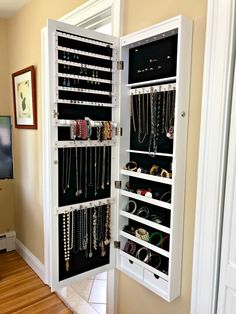 a white cabinet filled with lots of jewelry