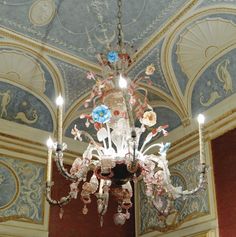 an ornate chandelier hangs from the ceiling