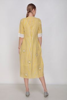 Yellow midi dress with stripe print, side pockets and floral embroidered motifs.
Component: 1
Printed
Neckine: Mandarin
Sleeve Length: Elbow
Fabric: Handwoven Noil Silk
Color: Yellow
Front button placket - Aza Fashions Cotton Short Sleeve Dresses With Vertical Stripes, Short Sleeve Cotton Dress With Vertical Stripes, Striped Maxi Dress For Daywear, Cotton Midi Dress With Floral Embroidery, Cotton Dress With Vertical Stripes And Short Sleeves, Spring Cotton Dresses With Striped Sleeves, Cotton Spring Dresses With Striped Sleeves, Cotton Dresses With Striped Sleeves For Spring, Elegant Striped Cotton Midi Dress