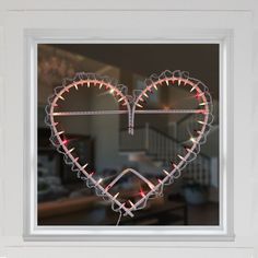 a heart shaped window with lights in it