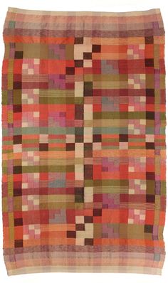 a multicolored patchwork rug with squares and lines on the bottom, in various colors