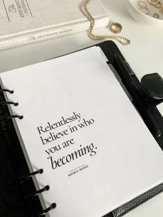 an open notebook with a quote on it