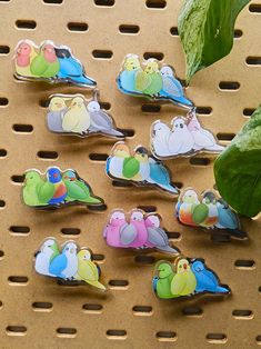 a group of birds sitting on top of a metal rack next to a green leaf