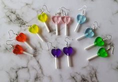 🍭How sweet!🍭These heart shaped lollipops are the perfect cute accessory!Measuring approx 4.3cm and made of translucent acrylic they're cute enough to eat (please don't!). Available with either silver plated or sterling silver ear wires with a choice of 6 colours!Matching keyrings and necklace available to order, just pop me a message! *note these earrings are NOT edible*All items are packaged in an organza gift bag, perfect for gifting or as a treat for yourselfAll items are free of lead and n 2p Italy, Star Lollipops, Outfit Recommendations, Heart Shaped Lollipops, Lollipop Earrings, Rainbow Images, Funny Kawaii, Funny Earrings, Crafting Jewelry