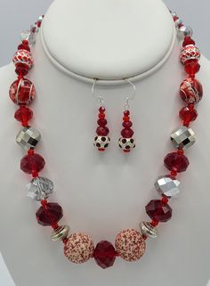 Necklace is 18 1/2 inches in length and is made with red and white specialty beads, silver crystal beads, red crystal beads, red specialty beads and red and silver specialty beads.  It has a sterling silver jump ring and a sterling silver lobster claw clasp.   Earrings are made from a red and silver round specialty bead and red crystals.  They hang a total of 1 3/4 inches in length and have a sterling silver earring wire. Red Round Beads Jewelry For Christmas, Red Faceted Beads Jewelry For Christmas, Red Faceted Round Bead Jewelry, Red Faceted Round Beads Jewelry, Red Faceted Round Beaded Jewelry, Adjustable Red Jewelry With Silver Beads, Red Beaded Sterling Silver Necklaces, Red Beaded Sterling Silver Necklace, Red Beaded Necklace With Silver Beads