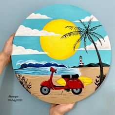 a person holding up a painted plate with a scooter and palm tree on it