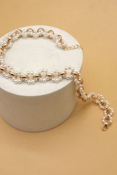 A beautiful choker featuring a mix of pearl and gold chain. DIMENSIONlength: 12"ext: 3" Ball Chain Extclasp: Lobster Clawmetal finish: Gold Platedproduct: Lead & Nickel Compliantanti-tarnish: Double E-coating Luxury 22k Gold Jewelry With Pearl Chain, Gold Pearl Choker Chain Necklace, Gold Pearl Chain Choker For Party, Gold Pearl Choker With Adjustable Chain, Gold Choker With Pearl Charm For Party, Gold Metal Choker With Pearl Chain, Beautiful Chokers, Layered Chain Necklace, Sunglass Chain