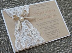 the wedding card is decorated with lace and ribbon, which has a bow on it