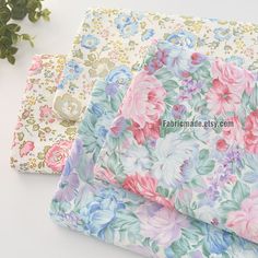 three different colored floral fabrics on top of each other