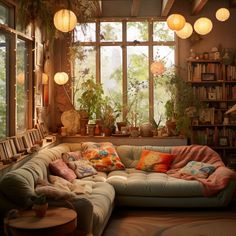 a living room filled with furniture and lots of plants on the windows sills